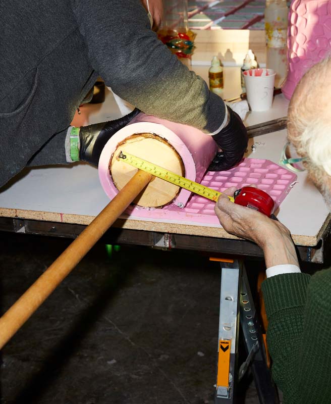 Man Measuring An Ice Bucket Being Rolled