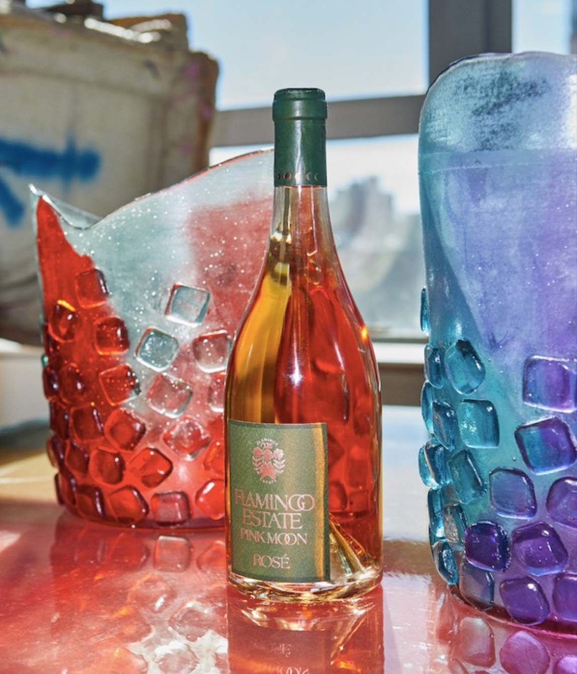 Bottle Of Flamingo Estate Rosé Surrounded By Two Textured Ice Buckets