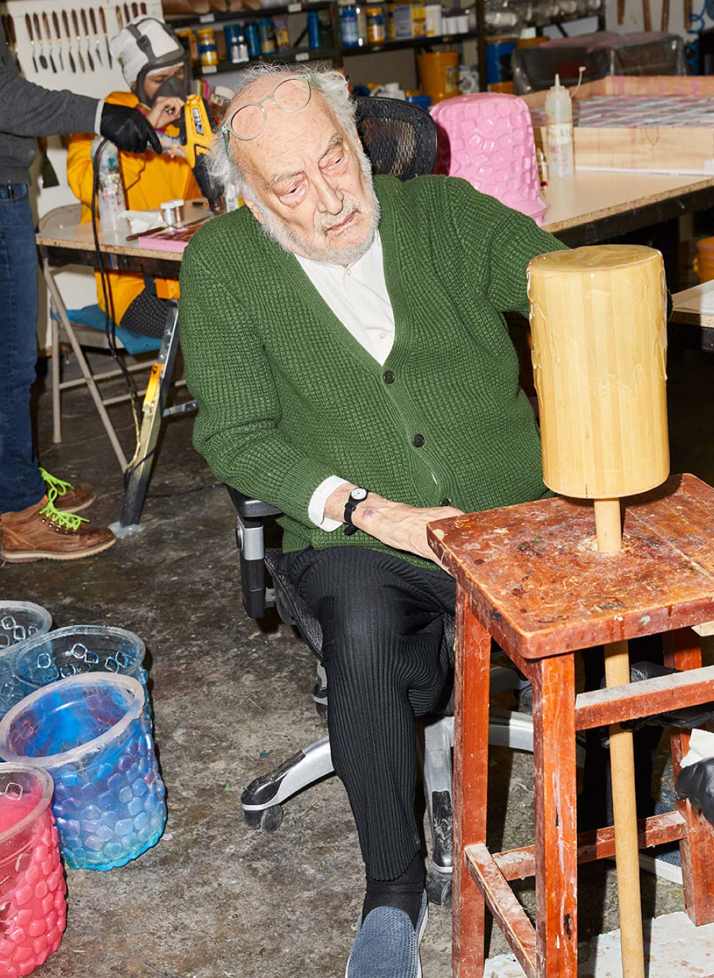 Man Working With A Wooden Cylinder In A Workshop