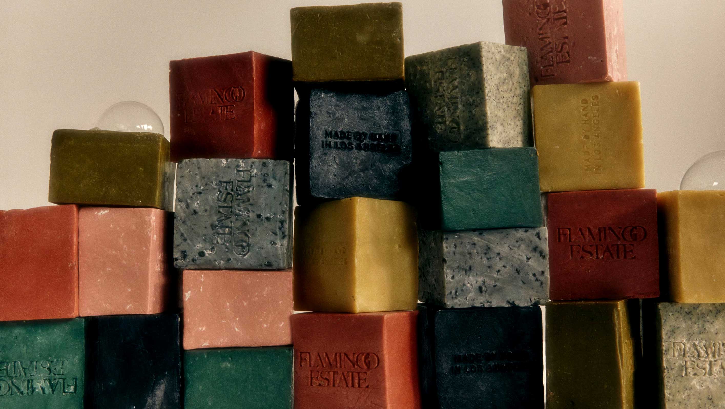 Stacks of colorful, rectangular soap bars arranged in towers.